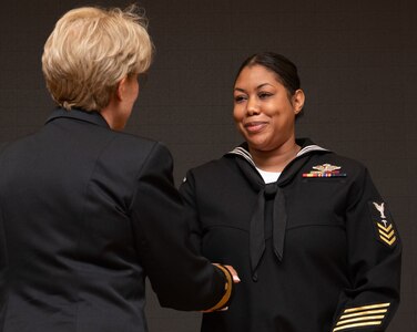 230406-N-DQ752-0015 SAN ANTONIO, Texas (Apr. 6, 2023) Hospital Corpsman 1st Class Aisha R. Thomas, Naval Medical Leader and Professional Development Command, shakes the hand of Rear Adm. Cynthia A. Kuehner, commander of Naval Medical Forces Support Command (NMFSC) after being selected as the NMFSC 2023 Sailor of the Year on April 6. (U.S. Navy Photo by Mass Communication Specialist 2nd Class Cheyenne Geletka)