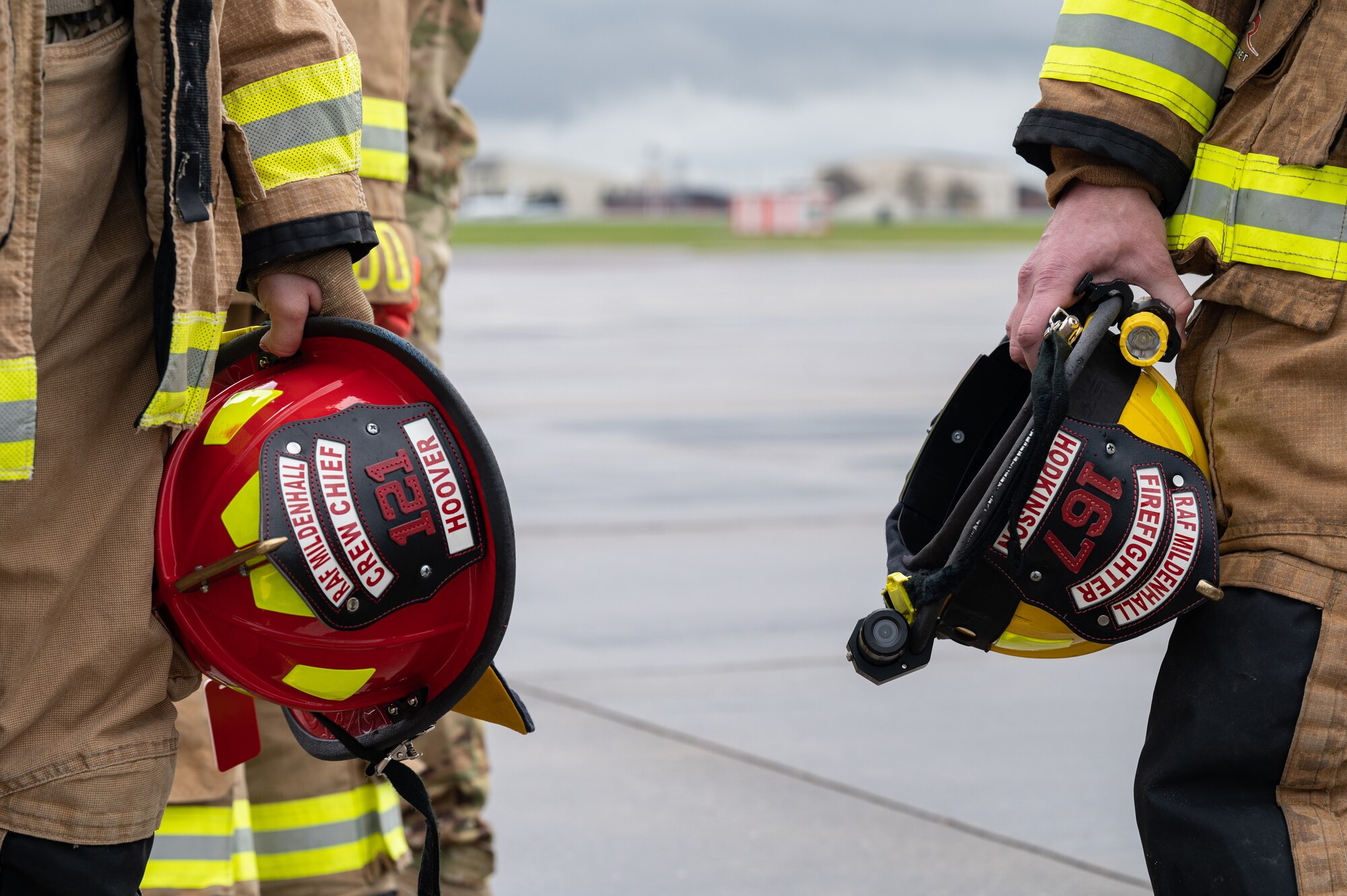 U.S. Air Force Tech. Sgt. Jessica Hoover, left, and Daniel Hodkinson, right, 100th Civil Engineering Squadron firefighters, stand together after extinguishing a simulated fire of a CV-22B Osprey aircraft assigned to the 352nd Special Operations Wing, March 31, 2023, at Royal Air Force Mildenhall, England.