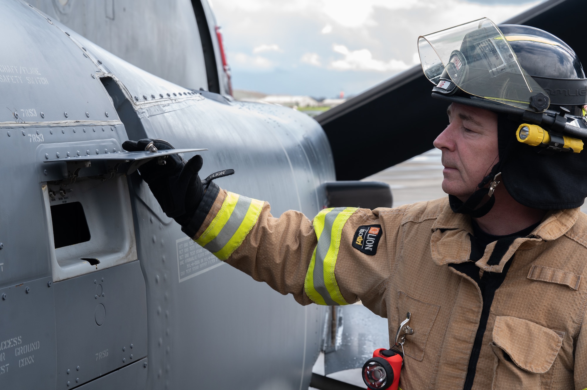 Paul Oakes, 100th Civil Engineering Squadron firefighter, looks at the rear door switches of a 352nd Special Operations Wing CV-22B Osprey aircraft fire, March 31, 2023, at Royal Air Force Mildenhall, England.