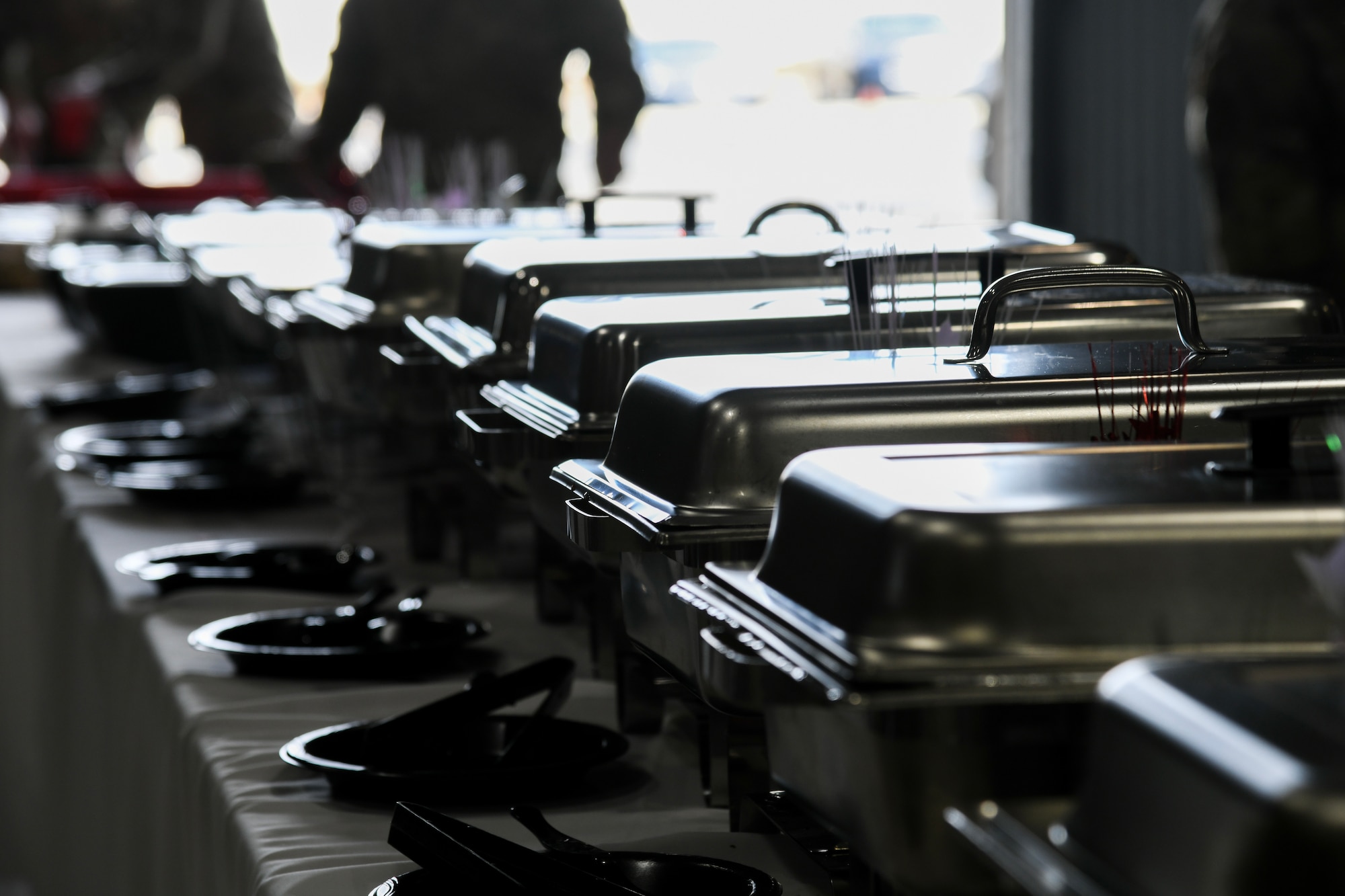 A photo of a line of chafing dishes sitting on a table.