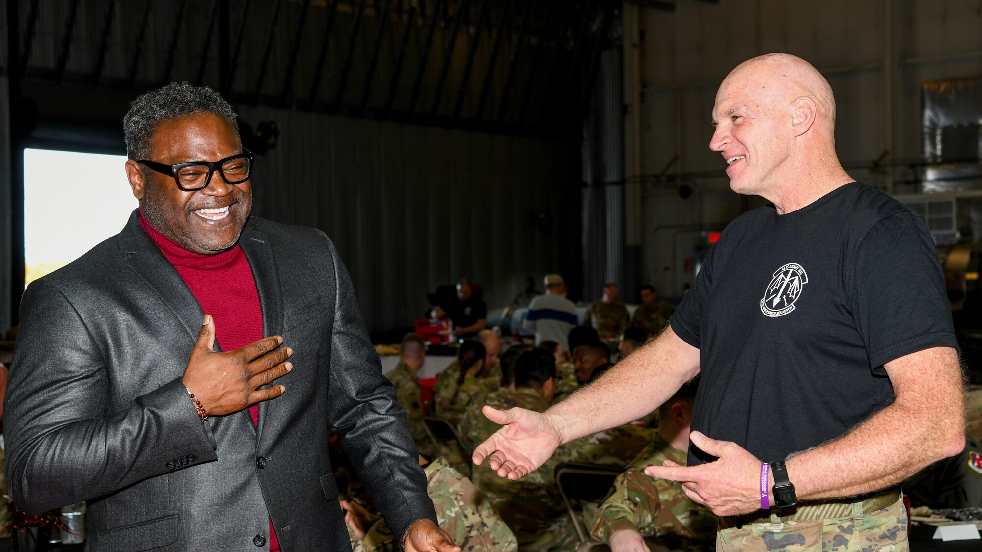 A photo of Senior Master Sgt. Michael D. Valiante, 177th Maintenance Group equipment maintenance flight senior enlisted leader, right, speaks to Mr. Gary Melton, Sr. during the 177th Maintenance Professional of the Year Banquet.