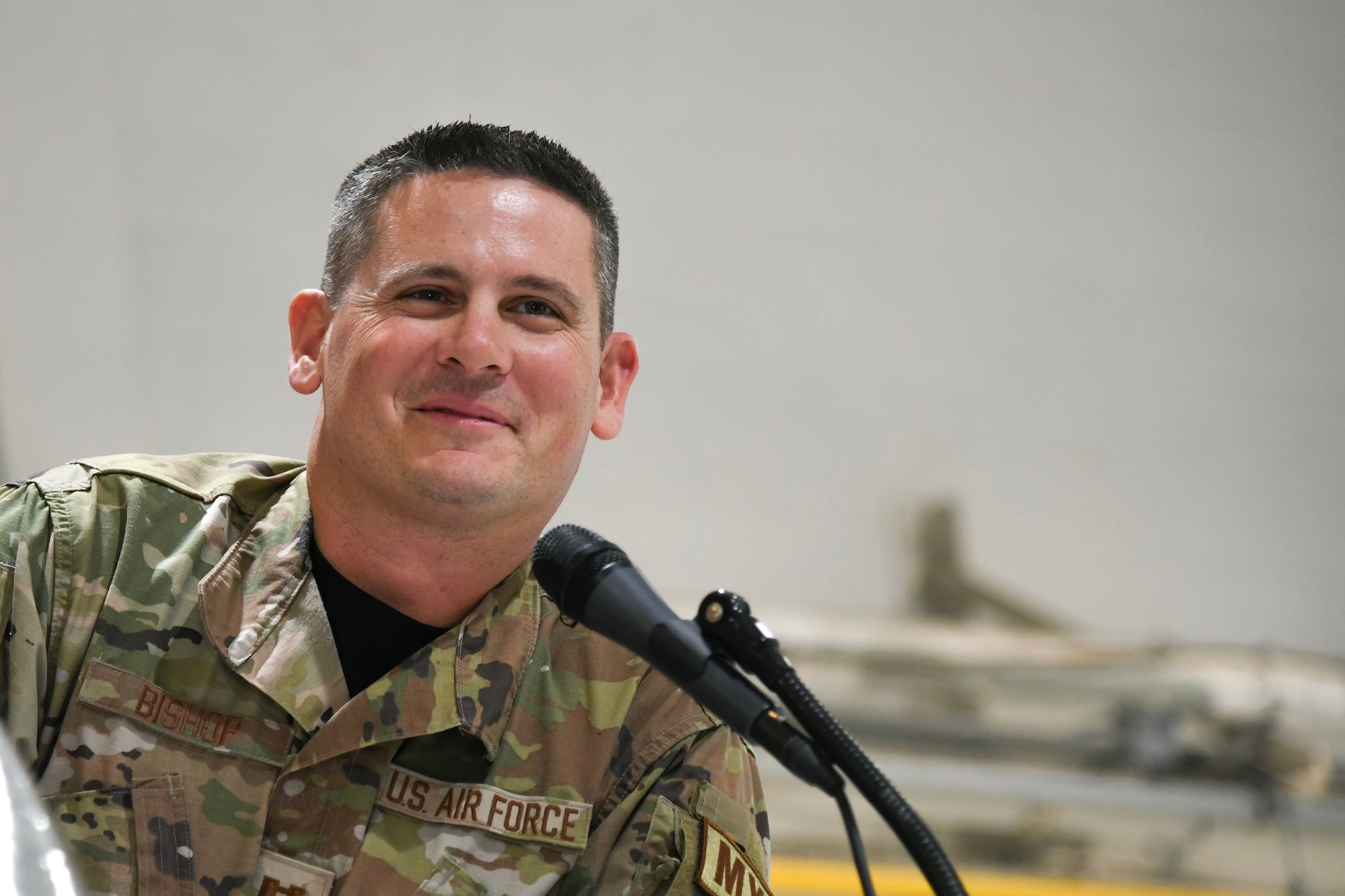 A photo of Capt. Michael Bishop, 177th Maintenance Squadron director of operations, speaking at a podium.