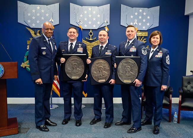 Air Force Chief of Staff Gen. CQ Brown, Jr. and Chief Master Sgt. of the Air Force JoAnne S. Bass pose with Col. Carl Miller, second from left, Lt. Col. Justin Burrier and Master Sgt. Jeffrey Fitzgerald, recipients of the 2019 Lance P. Sijan USAF Leadership Awards, during a ceremony at the Pentagon, Arlington, Va., April 3, 2023. The award is named for Medal of Honor recipient Capt. Lance Sijan, who died while being held as a prisoner of war during the Vietnam War. (U.S. Air Force photo by Eric Dietrich)