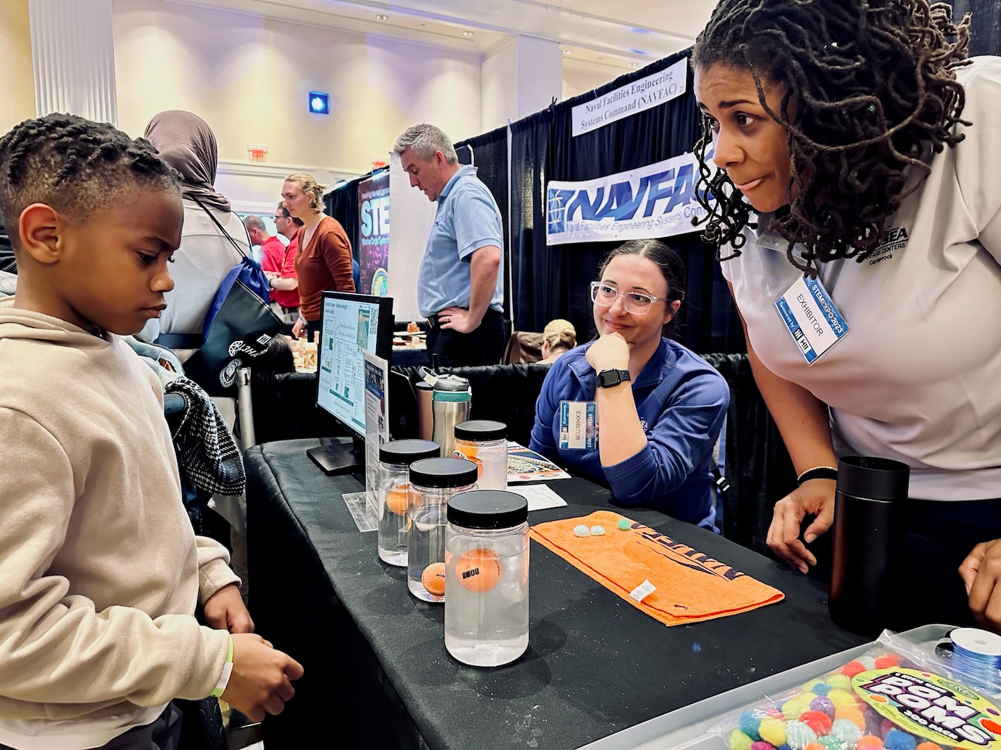 Naval Surface Warfare Center, Carderock Division engineers Charlotte George and Ashlee Floyd showcase STEM-in-a-Box activities on topics such as buoyancy and drag to a packed house during the Office of Naval Research STEM event to kick off Sea-Air-Space 2023 at the Gaylord Convention Center in National Harbor, Md., on April 2. (U.S. Navy photos by Monica McCoy)