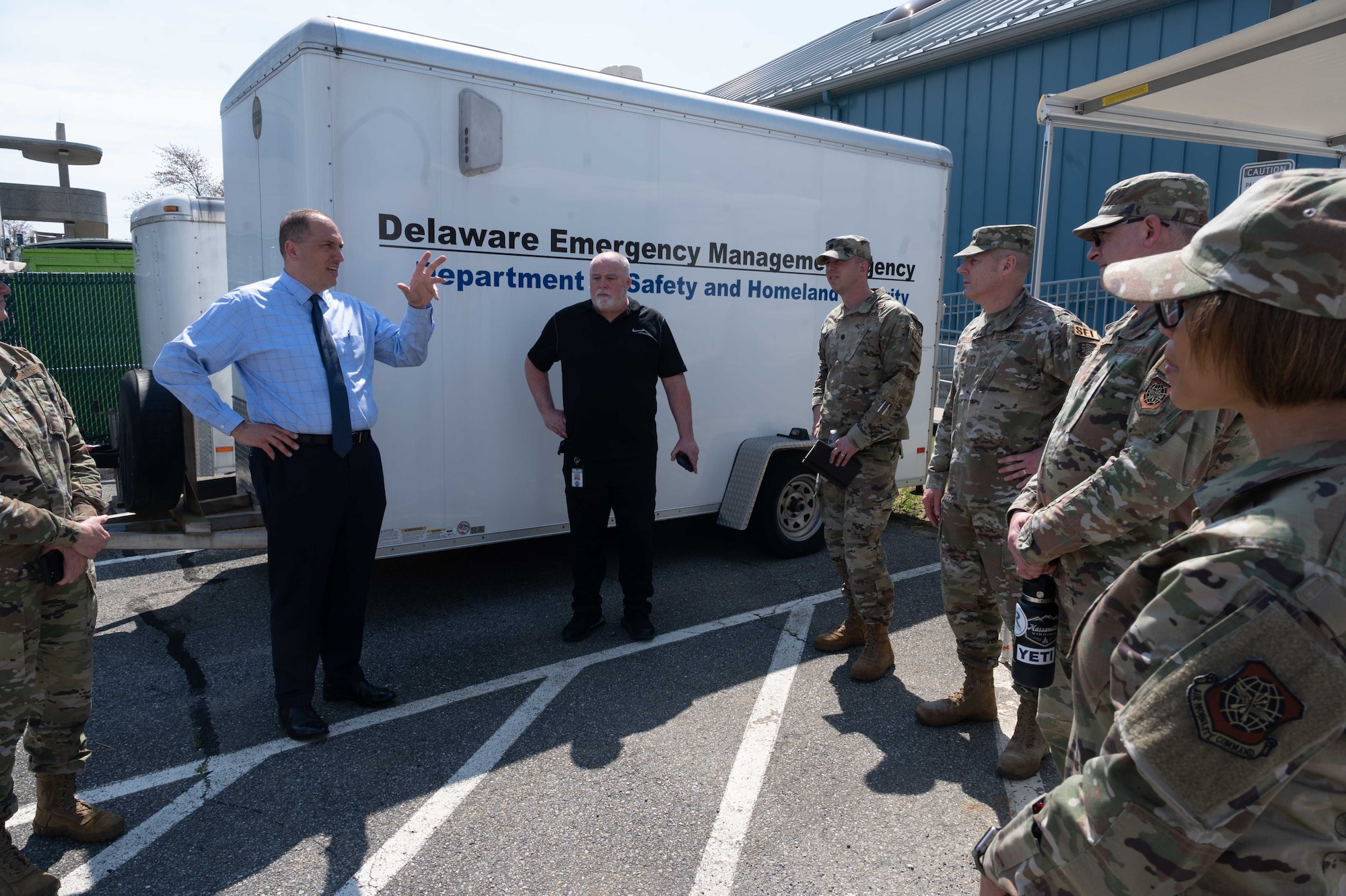 Representatives from the 436th Mission Support Group and the 512th MSG pose for a photo in front of the Delaware Emergency Management Agency Emergency Operations Center in Smyrna, Delaware, April 6, 2023. During the immersion event, DEMA was able to share best practices with Team Dover Airmen regarding preparedness for natural disasters, terrorism response, emergency operations center training, behavior threat analysis for school safety and community engagement. (U.S. Air Force photo by Senior Airman Faith Barron)