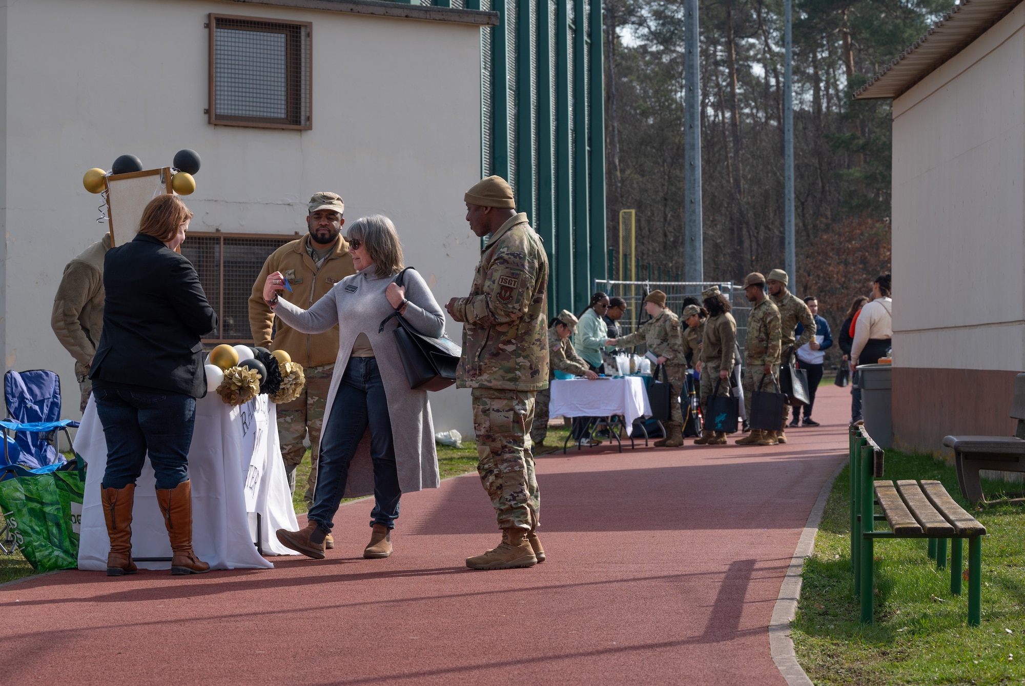 Participants at the Sexual Assault Prevention and Response Volksmarch event meet multiple helping agencies while walking around a running track at Ramstein Air Base, Germany, April 6, 2023. The SAPR program here offers resources to victims and can be reached through their hotline number +49 (0)6371-47-7272. (U.S. Air Force photo by Senior Airman Andrew Bertain)