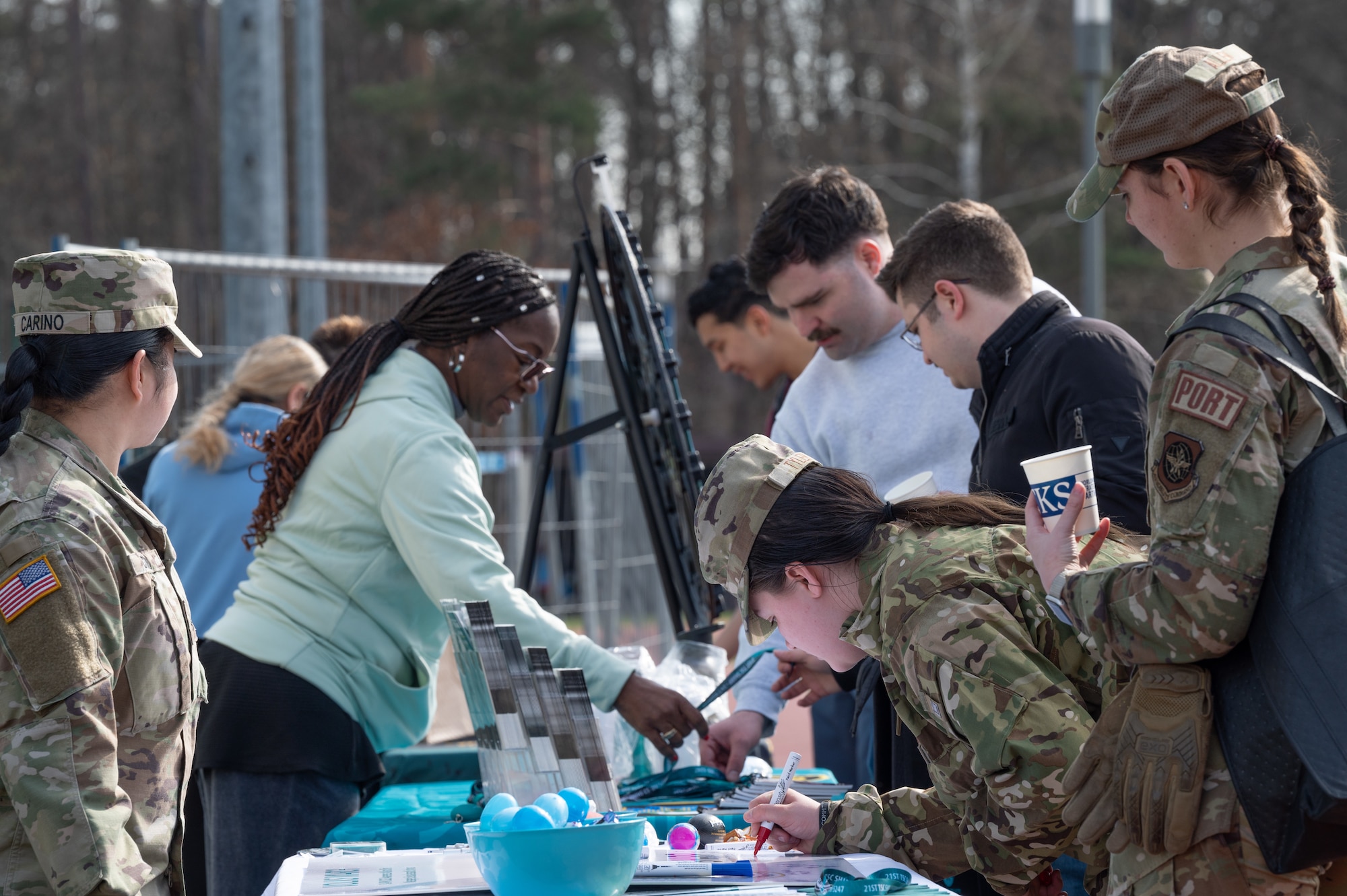 Members from the U.S. Army Sexual Harassment/Assault Response and Prevention program meet participants at the Sexual Assault Prevention and Response Volksmarch event, at Ramstein Air Base, Germany, April 6, 2023. The SAPR Volksmarch event hosted helping agencies from around the Kaiserslautern Military Community and had interactive games and art projects to open up discussions about sexual assault response and prevention resources. (U.S. Air Force photo by Senior Airman Andrew Bertain)