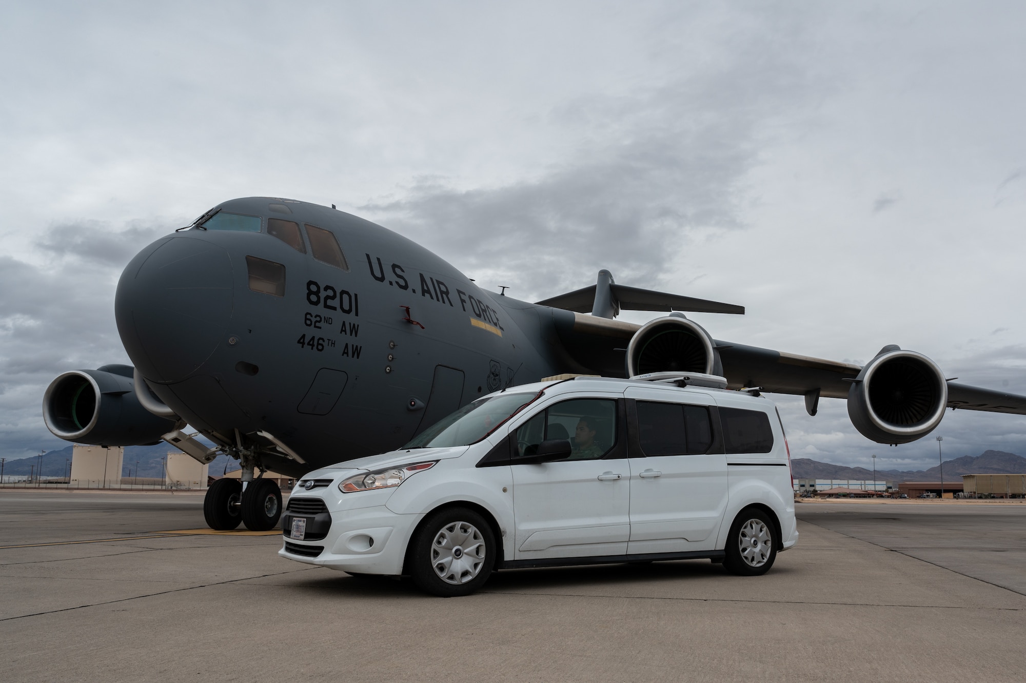 A C-17 is parked next to a van used in the Command and Control Element during Black Flag 23-1 at Nellis Air Force Base, Nevada, Feb. 23, 2023. This operation was accomplished by the combined effort between the C2 teams both on the ground and on the C-17 as they shared real time data to facilitate live operations. (U.S. Air Force photo by Airman 1st Class Josey Blades)