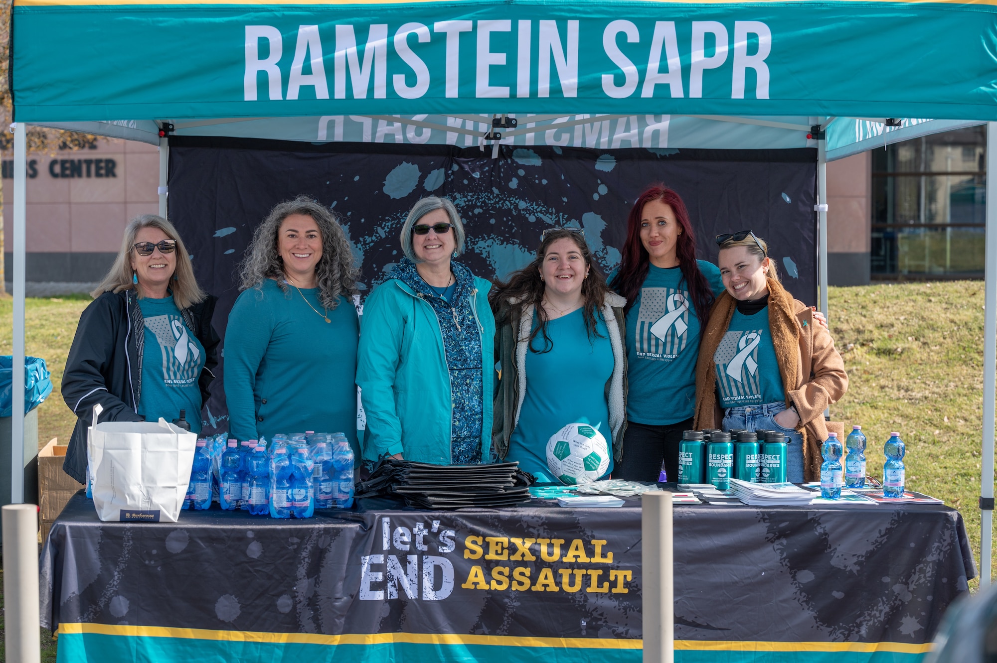 The Ramstein Air Base Sexual Assault Prevention and Response team gather for a group photo at a Volksmarch event, a sexual assault awareness walk and fair, at Ramstein Air Base, Germany, April 6, 2023. The SAPR team hosted the event to highlight sexual assault awareness and prevention month. (U.S. Air Force photo by Senior Airman Andrew Bertain)