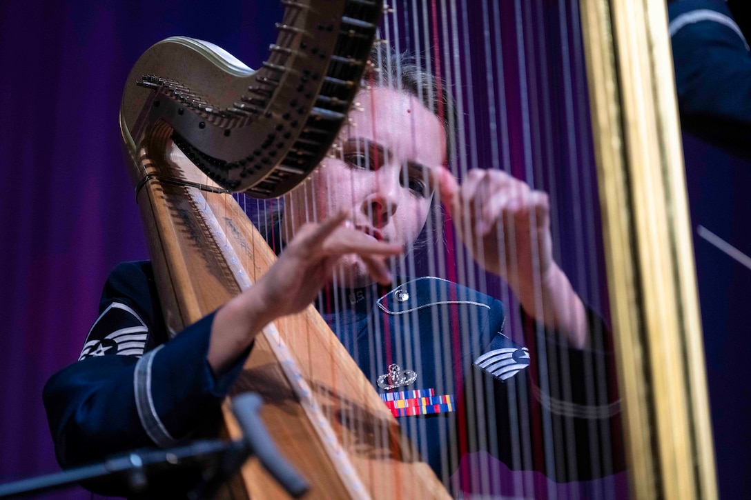 An airman plays the harp.