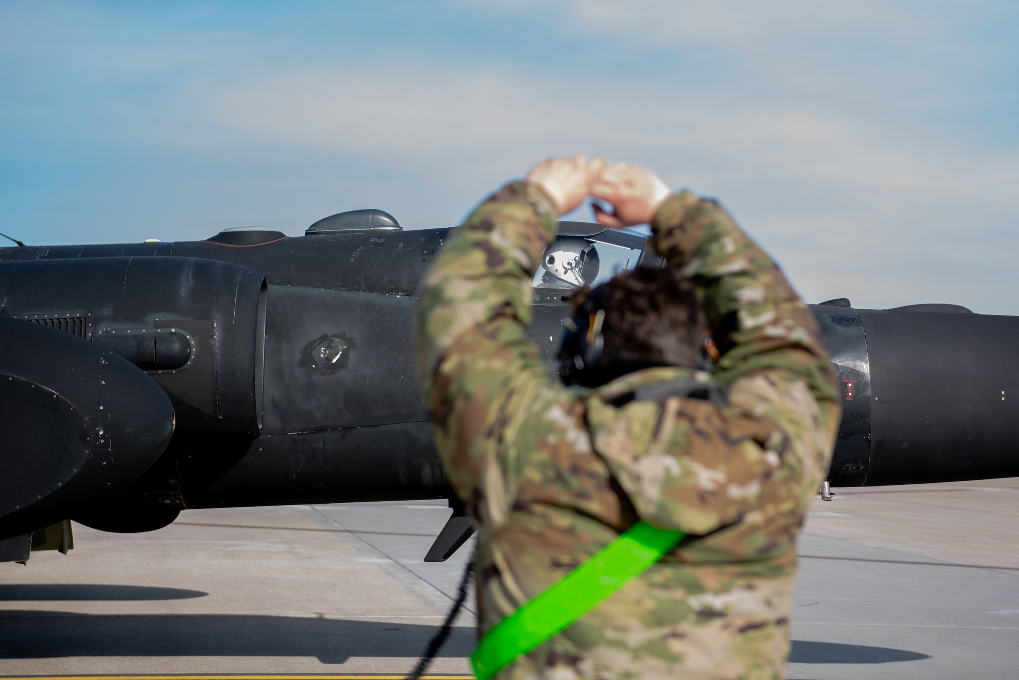 A U.S. Air Force 9th Aircraft Maintenance Squadron crew chief marshals a 99th Reconnaissance Squadron U-2 Dragon Lady pilot as they begin to taxi April 1, 2023, at Offutt Air Force Base, Nebraska.