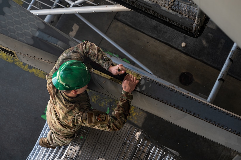 U.S. Air Force Senior Airman Jaylin Pittman, 305th Maintenance Squadron crew chief, checks tension on a boom pole during the final KC-10 Extender inspection at Joint Base McGuire-Dix-Lakehurst, N.J., April 10, 2023.