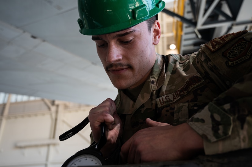 U.S. Air Force Senior Airman Jaylin Pittman, 305th Maintenance Squadron crew chief, checks tension on a boom pole during the final KC-10 Extender inspection at Joint Base McGuire-Dix-Lakehurst, N.J., April 10, 2023.