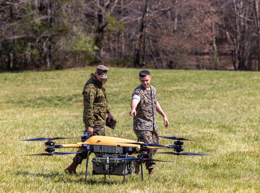 U.S. Marine Corps Cpl. Ian D. Lowe, Unmanned Logistics Systems-Air (ULS-A) operator, Combat Logistics Battalion 8, shows how to start the Tactical Resupply Unmanned Aircraft System (TRUAS) during a demonstration at DZ Cockatoo on Marine Corps Base Quantico, Virginia, March 29, 2023. Combat Development and Integration demonstrated the TRUAS, programming the ULS-A to carry a payload over a short distance, drop it at a specified location in the landing zone and return to its staring point. The TRUAS has a 9-mile range and maximum payload of 150 pounds, which is sufficient to fly in ammunition, food, medical supplies, and batteries, among other supplies. This small system only requires two Marines to operate and will be a game-changing capability for our distributed forces. Fielding this capability is a critical step in setting conditions for the development of the ULS-A Medium system, which is the required capability for large-scale tactical distribution in a contested space. (U.S. Marine Corps Photo by Lance Cpl. Kayla LeClaire)