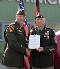 Col. Deon Maxwell, left, commander of the U.S. Army Medical Materiel Center-Europe, shakes hands with Sgt. Maj. Andrew Colburn to congratulate him on his promotion March 3, 2023, at USAMMC-E in Kaiserslautern, Germany. Colburn serves as senior enlisted adviser to the organization. (Courtesy)
