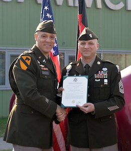 Col. Deon Maxwell, left, commander of the U.S. Army Medical Materiel Center-Europe, shakes hands with Sgt. Maj. Andrew Colburn to congratulate him on his promotion March 3, 2023, at USAMMC-E in Kaiserslautern, Germany. Colburn serves as senior enlisted adviser to the organization. (Courtesy)