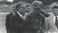 Historical photo of Protective Services and Secretary of Defense Harold Brown in 1974