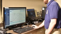 Special Agent examining Global Positioning System evidence in the lab