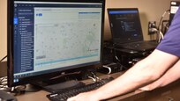Special Agent examining Global Positioning System evidence in the lab