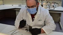 Forensic Scientist examining evidence in the lab