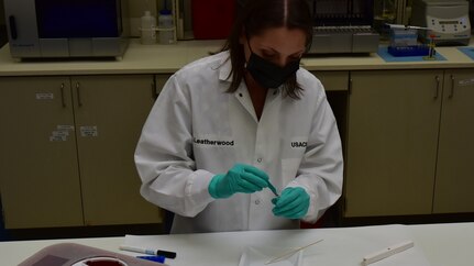 Forensic Scientist examining evidence in the lab