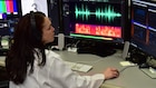 Forensic Scientist examining audio evidence in the lab
