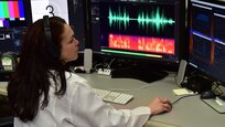 Forensic Scientist examining audio evidence in the lab
