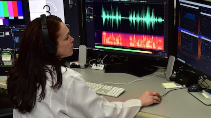 Forensic Scientist examining audio evidence in the lab