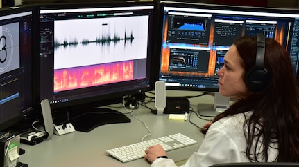 Forensic Scientist examining audio evidence in the lab