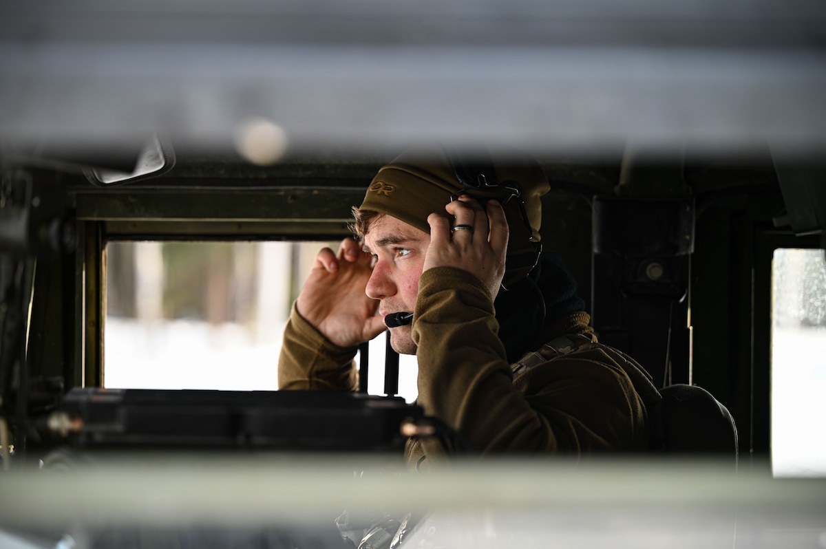 U.S. Air Force Staff Sgt. Lucanus Henk, 3rd Air Support Operations Squadron noncommissioned officer in charge of training, listens to an incoming message during an arctic training in Delta Junction, Alaska, March 23, 2023.
