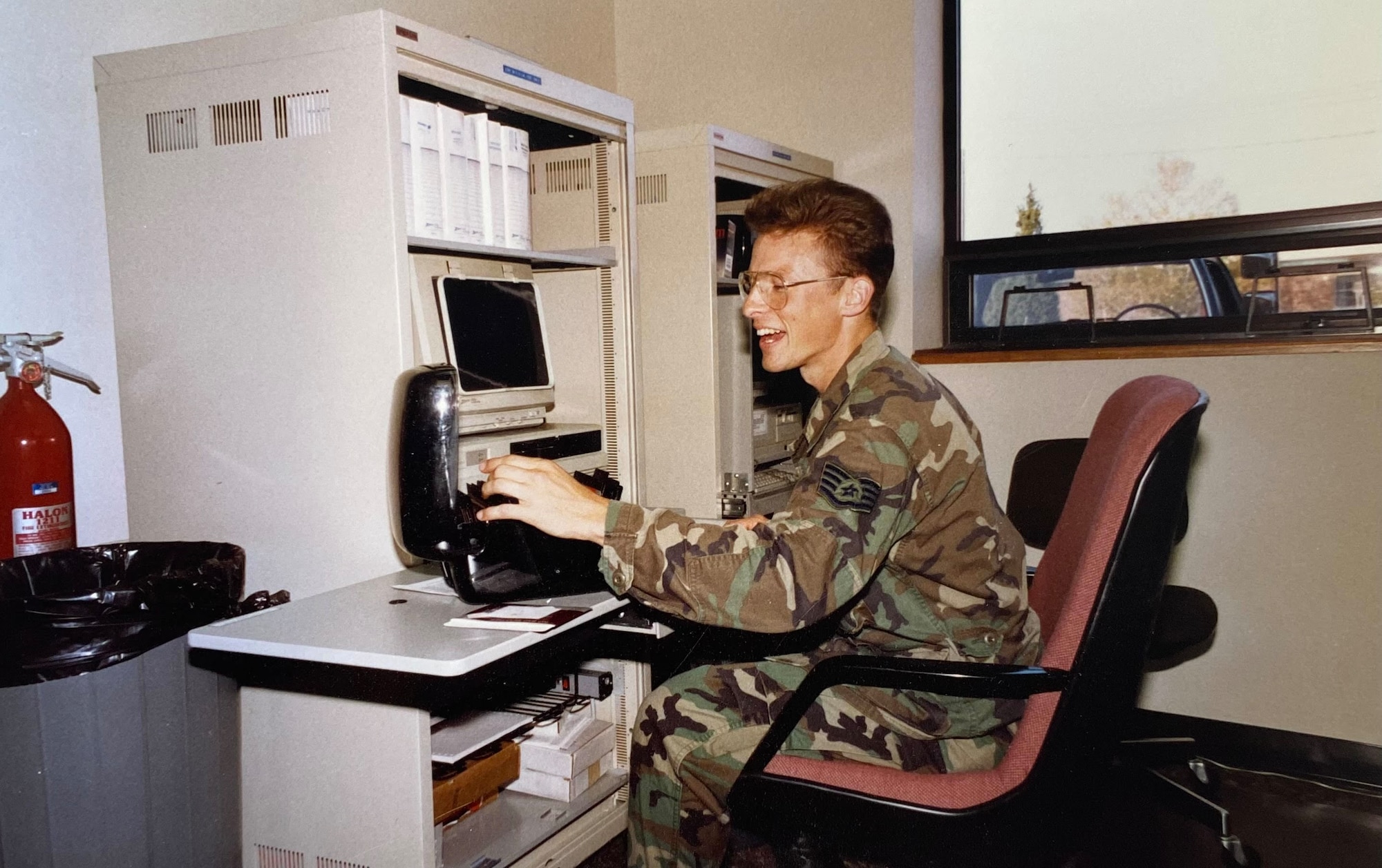 Chief Master Sgt. Frederick Balas works at a computer