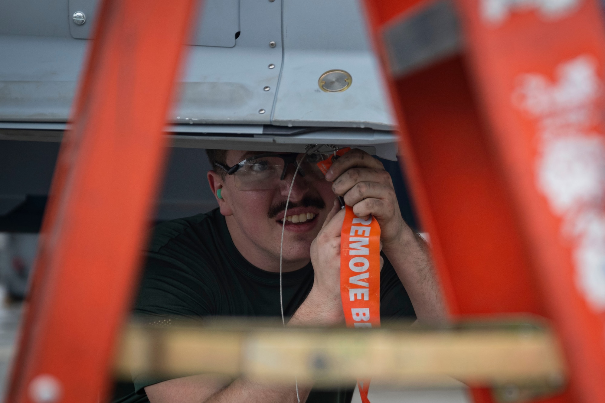 An Airman assigned to the 335th Fighter Generation Squadron prepares an F-15E Strike Eagle for weapons loading during a quarterly load crew competition at Seymour Johnson Air Force Base, North Carolina, April 7, 2023. Winners of the competition are awarded with bragging rights and a trophy. (U.S. Air Force photo by Senior Airman David Lynn)