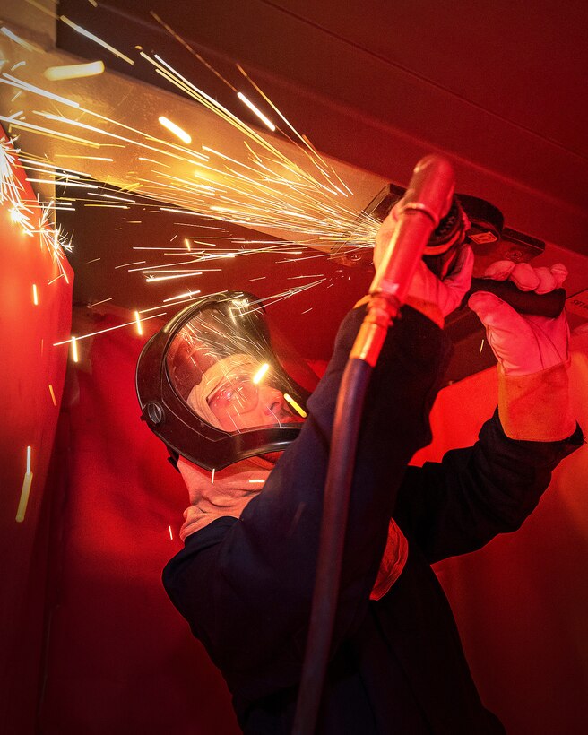 Sydney Bennett, shipfitter trainee, Shop 11, Shipfitter, works inside the newly re-dedicated School of Steel training facility April 5, 2023, at Puget Sound Naval Shipyard & Intermediate Maintenance Facility in Bremerton, Washington. (U.S. Navy photo by Wendy Hallmark)