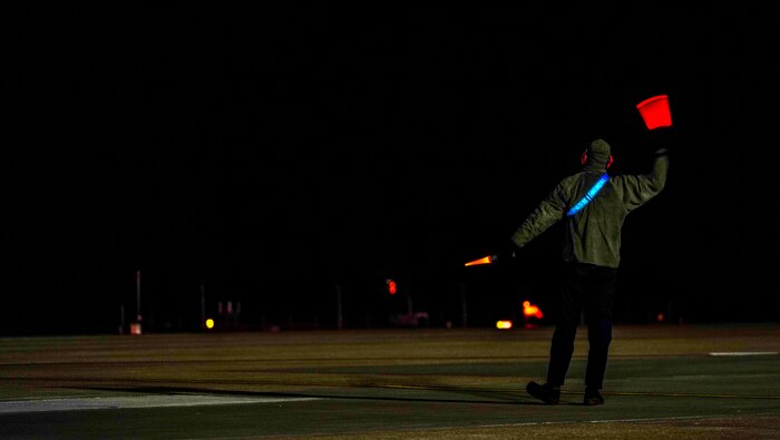 A U.S. Air Force 9th Aircraft Maintenance Squadron crew chief directs a U-2 Dragon Lady on the flightline March 27, 2023, at Offutt Air Force Base, Nebraska. Beale Airmen traveled to Offutt to participate in Dragon Flag EAST.