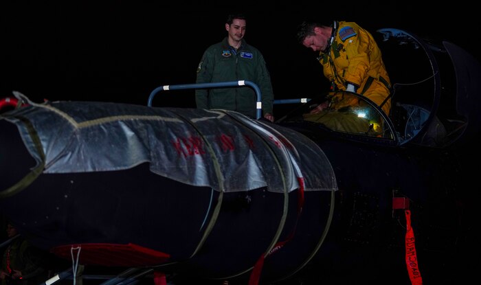 A U.S. Air Force 99th Reconnaissance Squadron U-2 Dragon Lady pilot climbs out of the cockpit assisted by 99th RS U-2 pilot March 27, 2023, at Offutt Air Force Base, Nebraska.