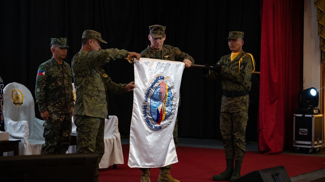 Philippine and U.S. military representatives conduct the unfurling of the flag during the opening ceremony to commence Balikatan 23 at Camp Aguinaldo, Manila, Philippines, April 11, 2023. Balikatan is an annual exercise between the Armed Forces of the Philippines and the U.S. military designed to strengthen bilateral interoperability, improve capabilities, and reinforce the shared security relationship built over decades of training and cooperation. More than 17,600 troops are participating in Balikatan 23, the 38th iteration of the exercise. (U.S. Air Force photo by Staff Sgt. Sadie Colbert)