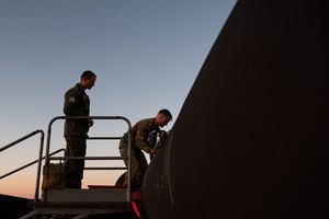 A U.S. Air Force 99th Reconnaissance Squadron U-2 Dragon Lady pilot and 9th Physiological Support Squadron Airman assist a 99th RS U-2 pilot after a high flight during Dragon Flag EAST, April 5, 2023, at Offutt Air Force Base, Nebraska.