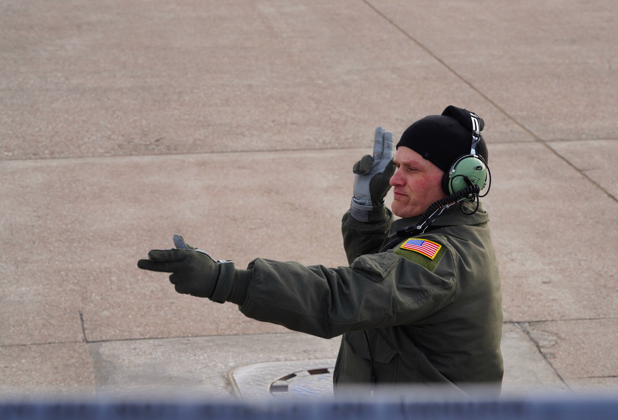 A U.S. Air Force 55th Wing RC-135V/W Rivet Joint pilot signals to a 9th Reconnaissance Wing U-2 Dragon Lady pilot prior to takeoff during Dragon Flag EAST, April 5, 2023, at Offutt Air Force Base, Nebraska.