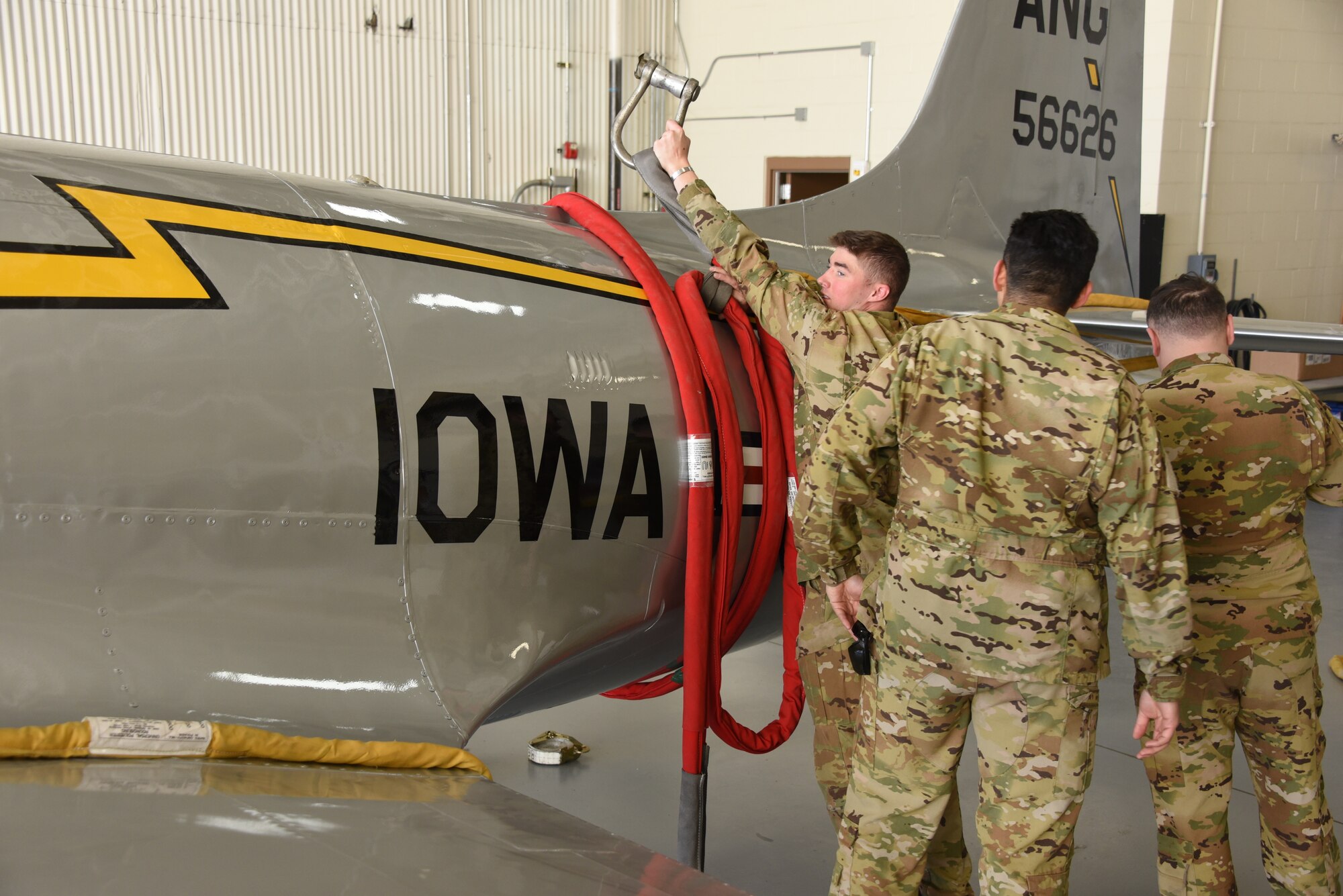 Iowa Army National Guard CH-47 Chinook helicopter picks up a F-80 fighter jet at the Air National Guard paint facility