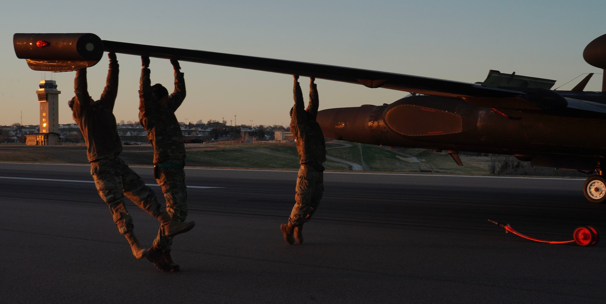 U.S. Air Force 9th Aircraft Maintenance Squadron Airmen and a 9th MXS aircraft egress mechanic weigh down the wing of a U-2 Dragon Lady for proper balance and to place a pogo during Dragon Flag EAST, April 5, 2023, at Offutt Air Force Base, Nebraska.