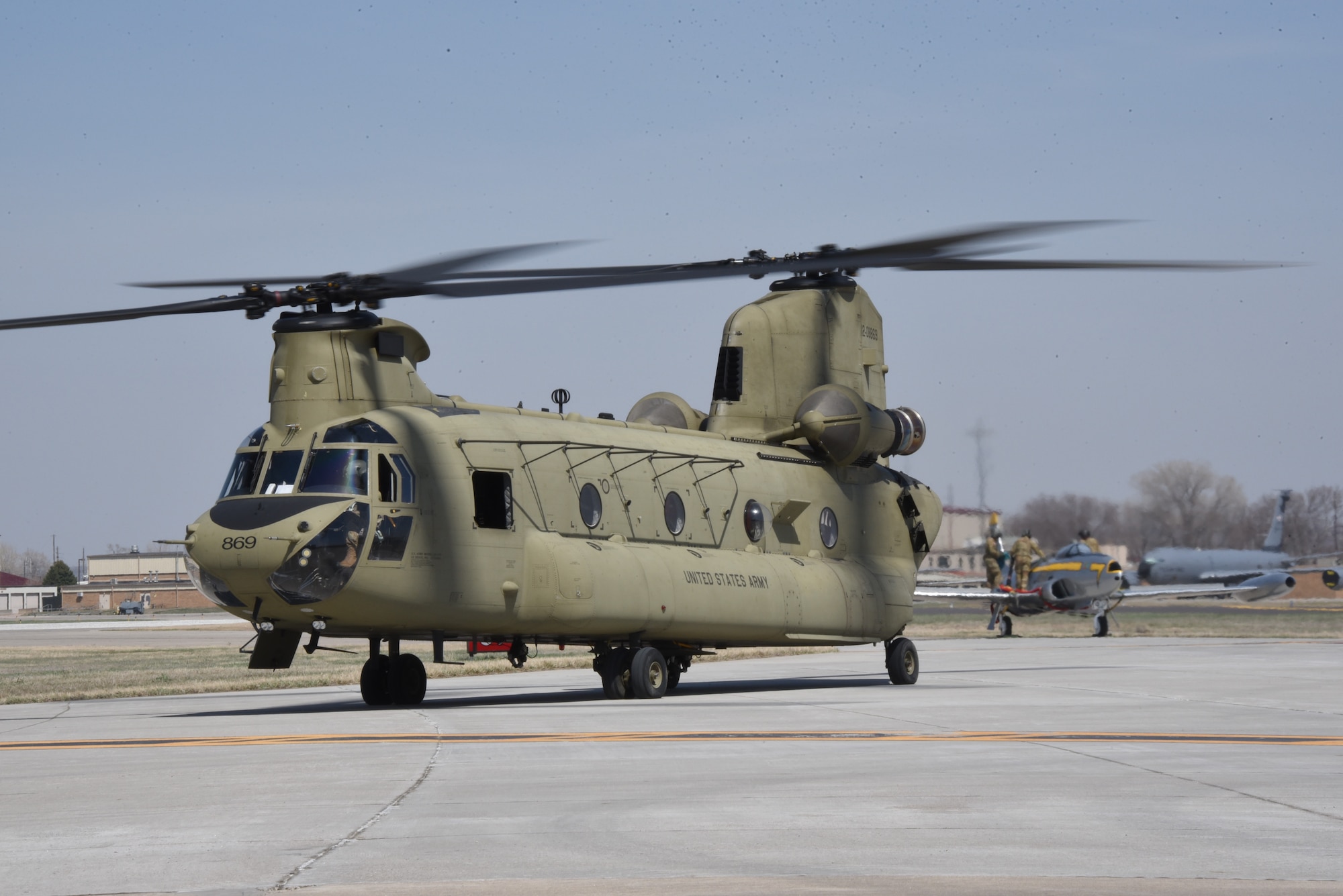 Iowa Army National Guard CH-47 Chinook helicopter picks up a F-80 fighter jet at the Air National Guard paint facility