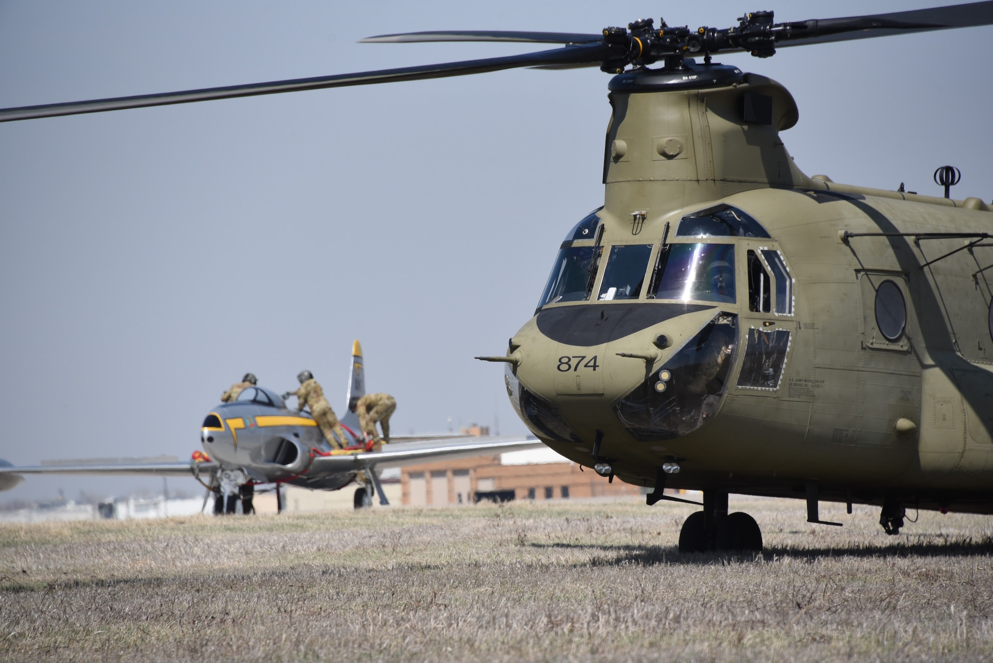 Iowa Army National Guard CH-47 Chinook helicopter picks up a F-80 fighter jet at the Air National Guard paint facility