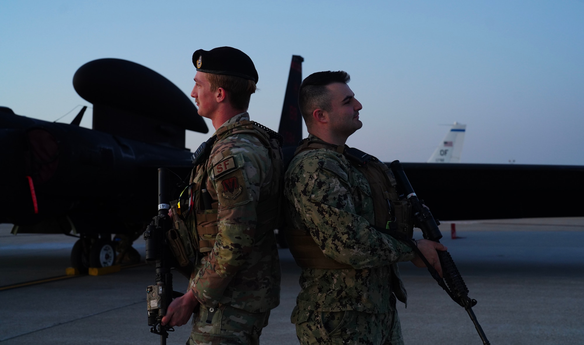 A U.S. Navy Master of Arms and a U.S. Air Force 55th Security Forces Squadron defender stand guard in front of a U-2 Dragon Lady during Dragon Flag EAST, April 5, 2023, at Offutt Air Force Base, Nebraska.