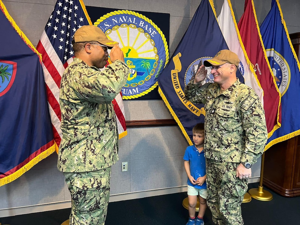 NAVAL BASE GUAM (April 6, 2023) - Cmdr. Stephen Ansuini, the outgoing executive officer of U.S. Naval Base Guam (NBG), salutes Cmdr. Phil Smith, the incoming executive officer for NBG during a turnover ceremony at the NBG Headquarters, April 6.