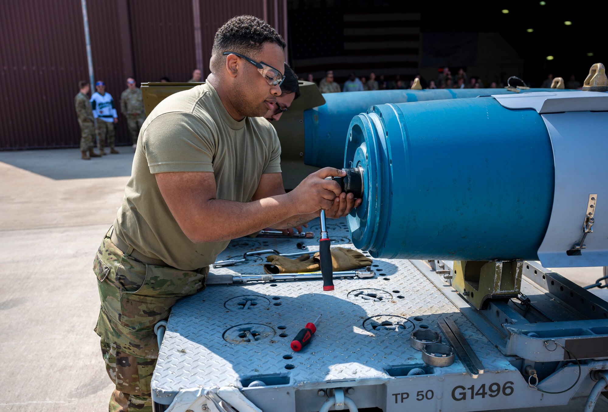 U.S. Air Force Staff Sgt. Jordan Zimmerman, 51st Munitions Squadron, participates in a weapons load crew of the quarter competition at Osan Air Base, Republic of Korea, March 31, 2023
