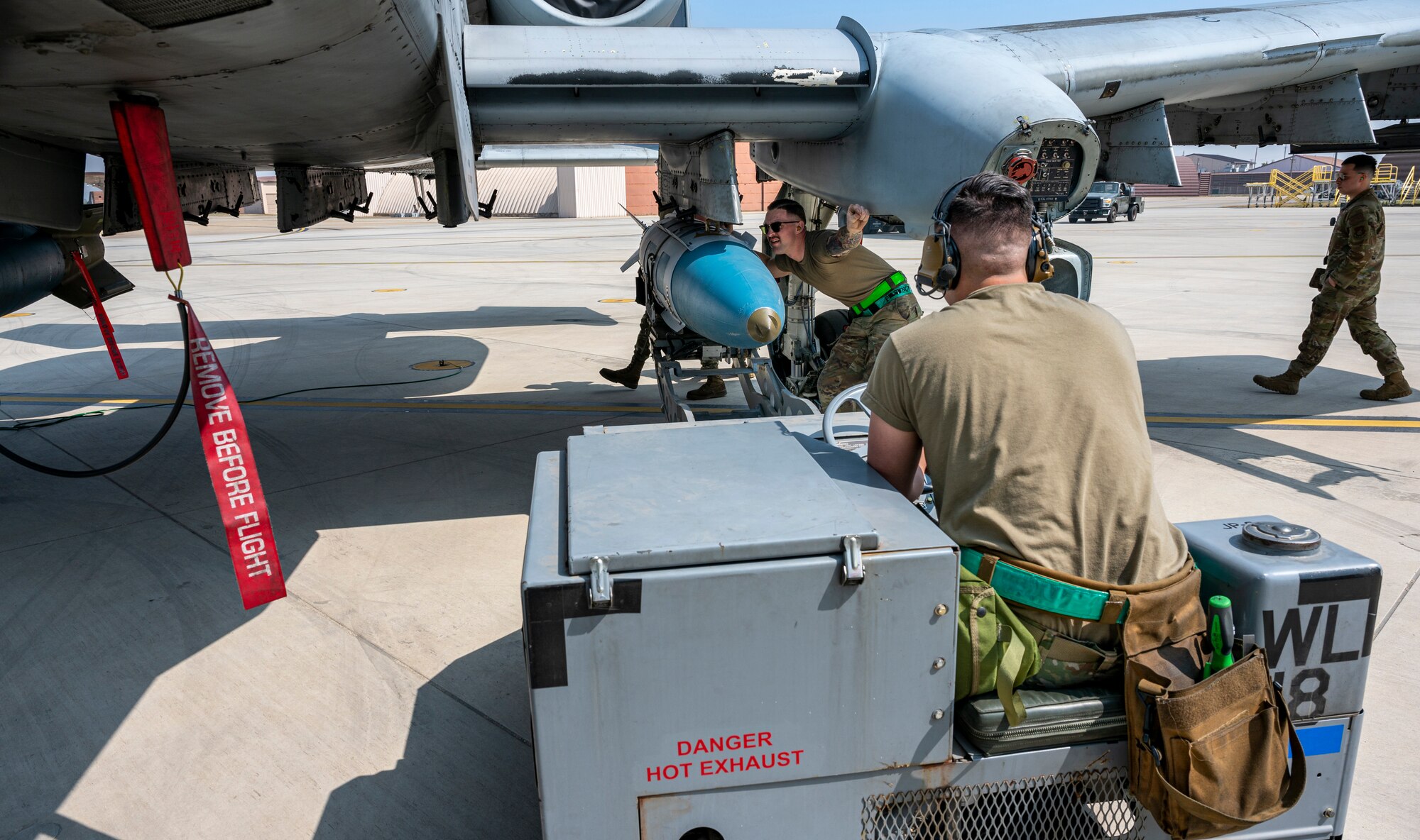 Weapons load crew members from the 25th Fighter Generation Squadron, prepare to load munitions onto an A-10C Thunderbolt II during a weapons load crew of the quarter competition at Osan Air Base, Republic of Korea, March 31, 2023.