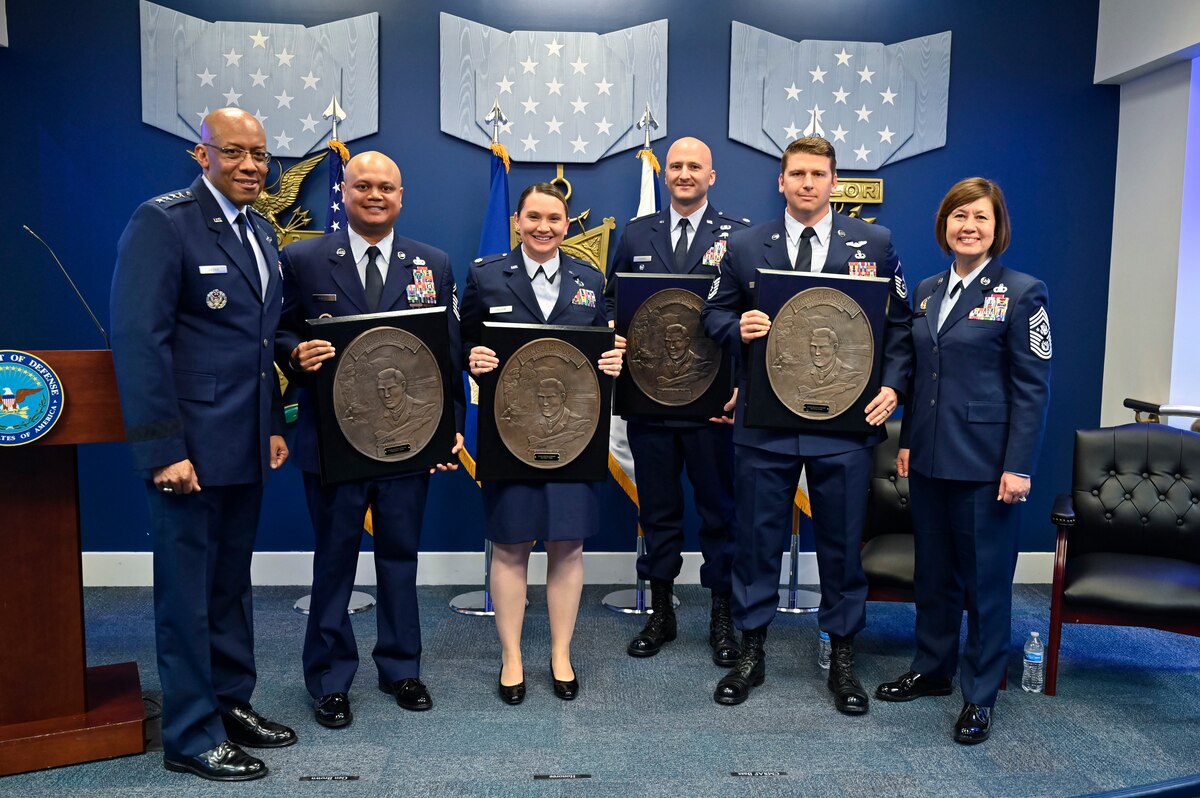 Air Force Chief of Staff Gen. CQ Brown, Jr. and Chief Master Sgt. of the Air Force JoAnne S. Bass pose with Senior Master Sgt. Jeremy Mapalo, second from left, Maj. Kasey Vaughn, Lt. Col. Steven Cooper and Master Sgt. Trevor Runyan, recipients of the 2020 Lance P. Sijan USAF Leadership Awards, during a ceremony at the Pentagon, Arlington, Va., April 3, 2023. The award is named for Medal of Honor recipient Capt. Lance Sijan, who died while being held as a prisoner of war during the Vietnam War. (U.S. Air Force photo by Eric Dietrich)