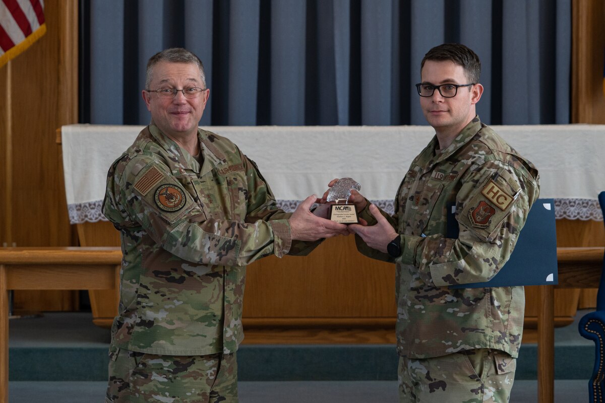 Major General gives award to Major while standing in chapel
