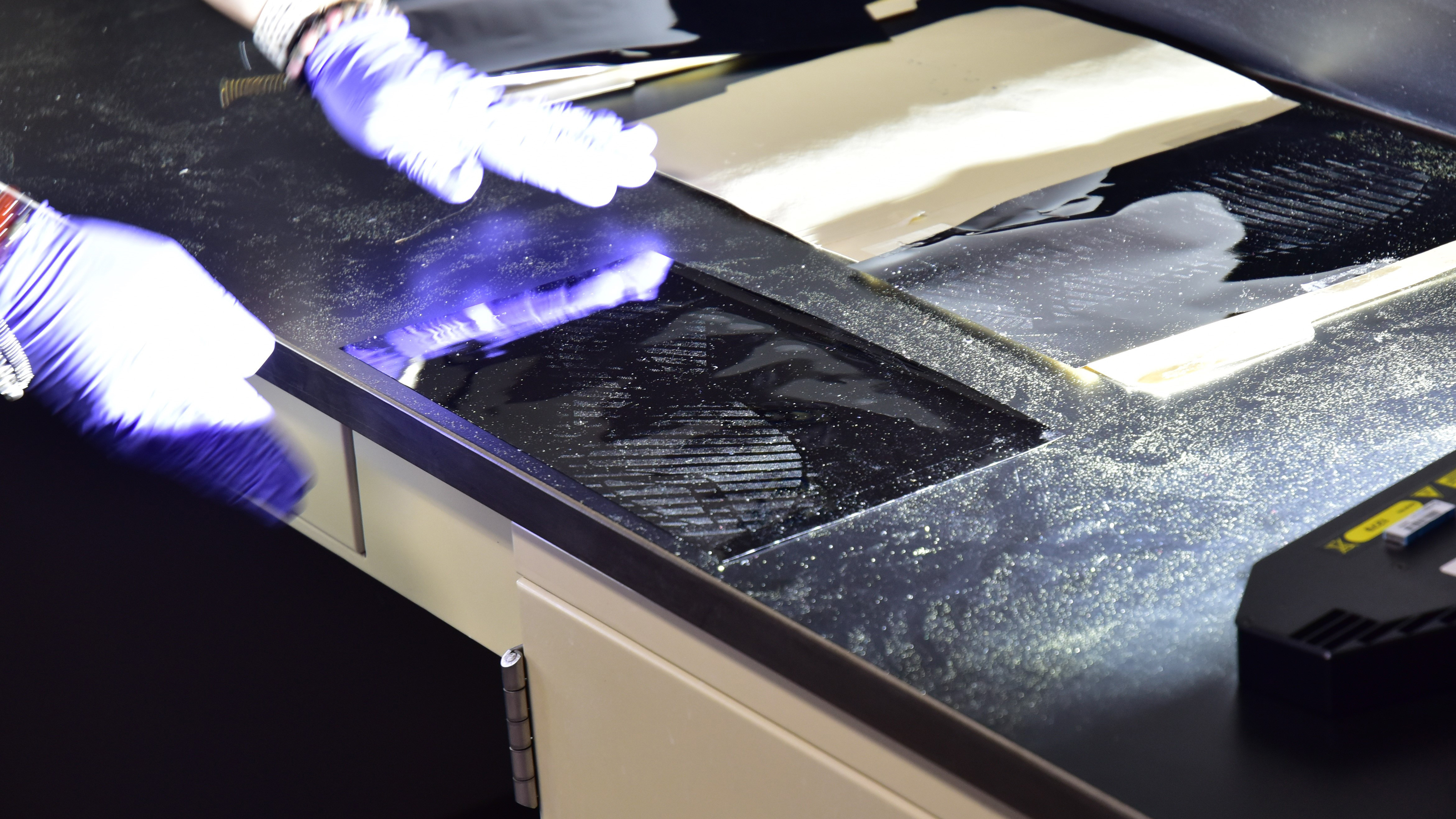 Forensic Scientist examining shoeprint evidence in the lab