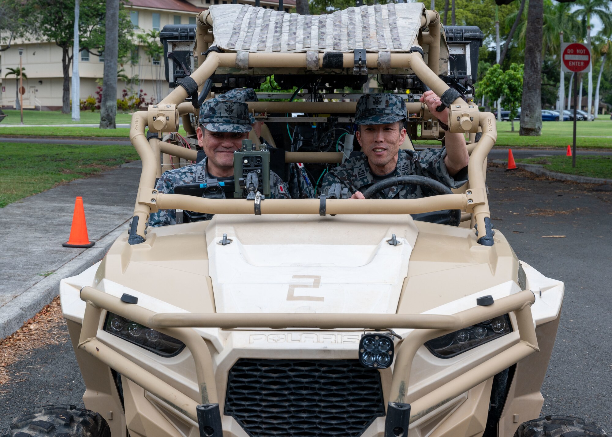 Photo of Japan Air Self Defense Force officers sitting in an Austere Environment Reconnaissance and Surveillance vehicle